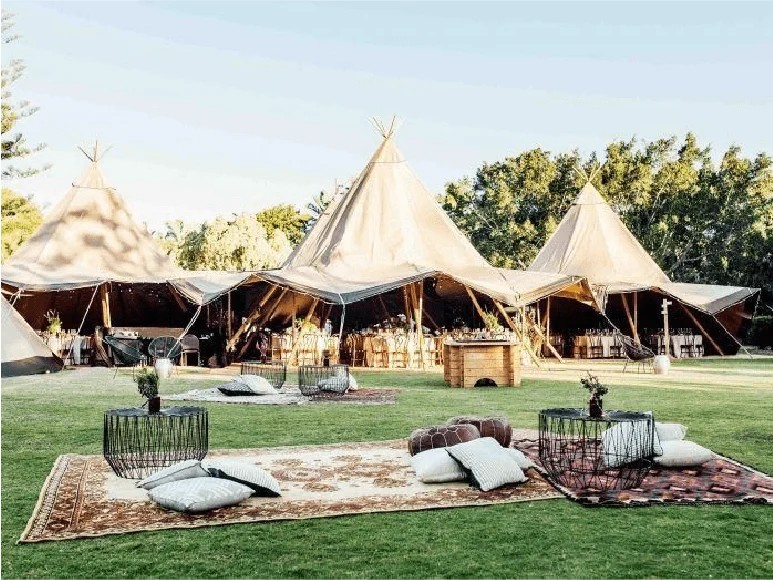 Linked tipis arranged around an outdoor seating area