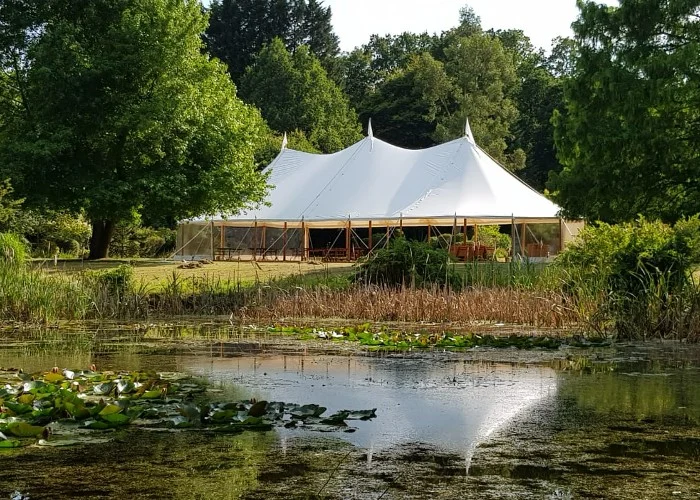 White marquee reflected in a lake