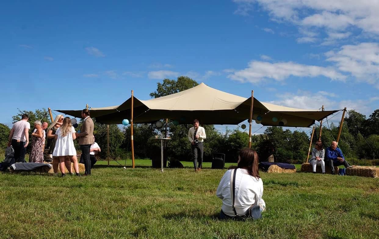 Guests outside an open-sided stretch tent — example for events in Bowdon