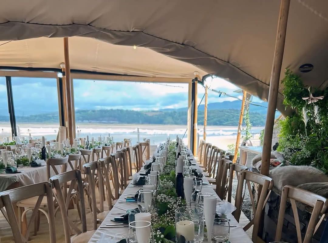 Long wedding dining table inside an open-sided marquee — example for events in Staffordshire