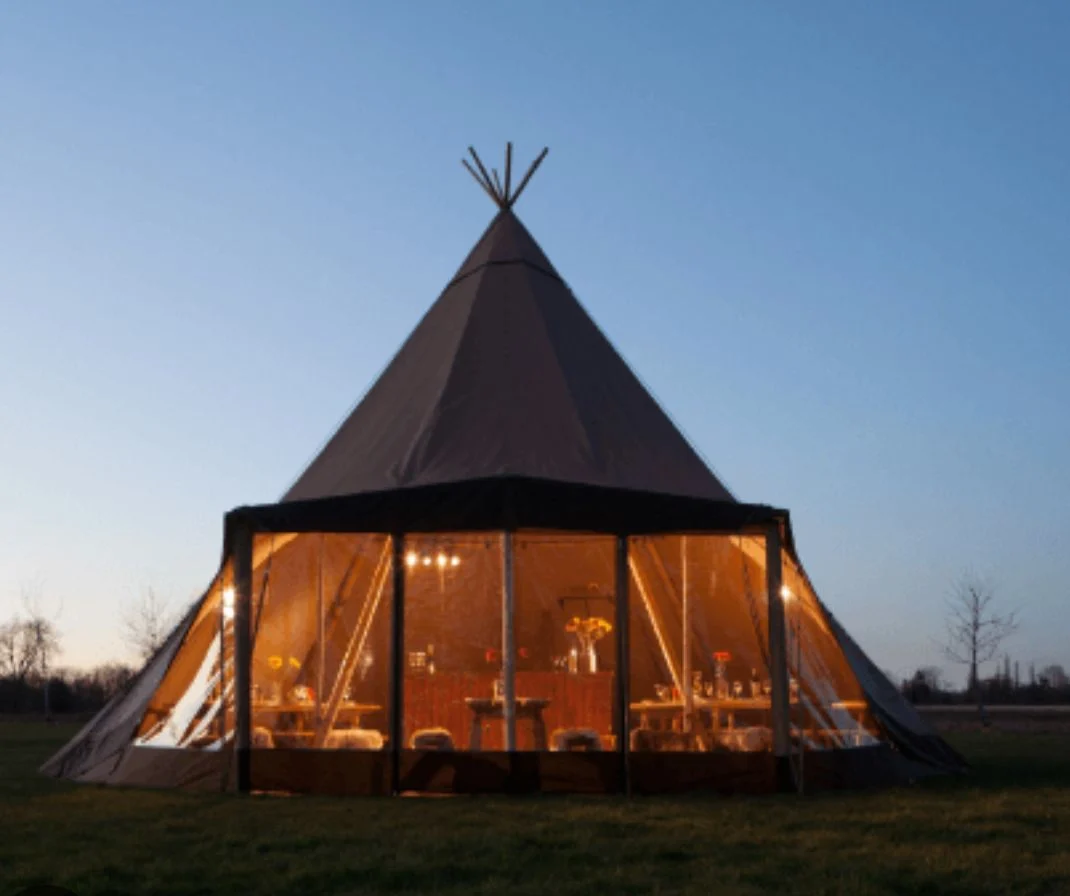 Single tipi illuminated at dusk — example for events in Staffordshire