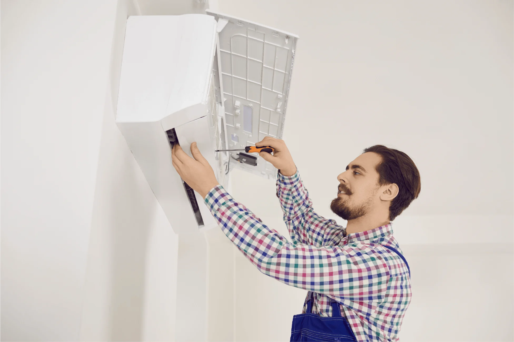 Person checking a wall ventilation unit