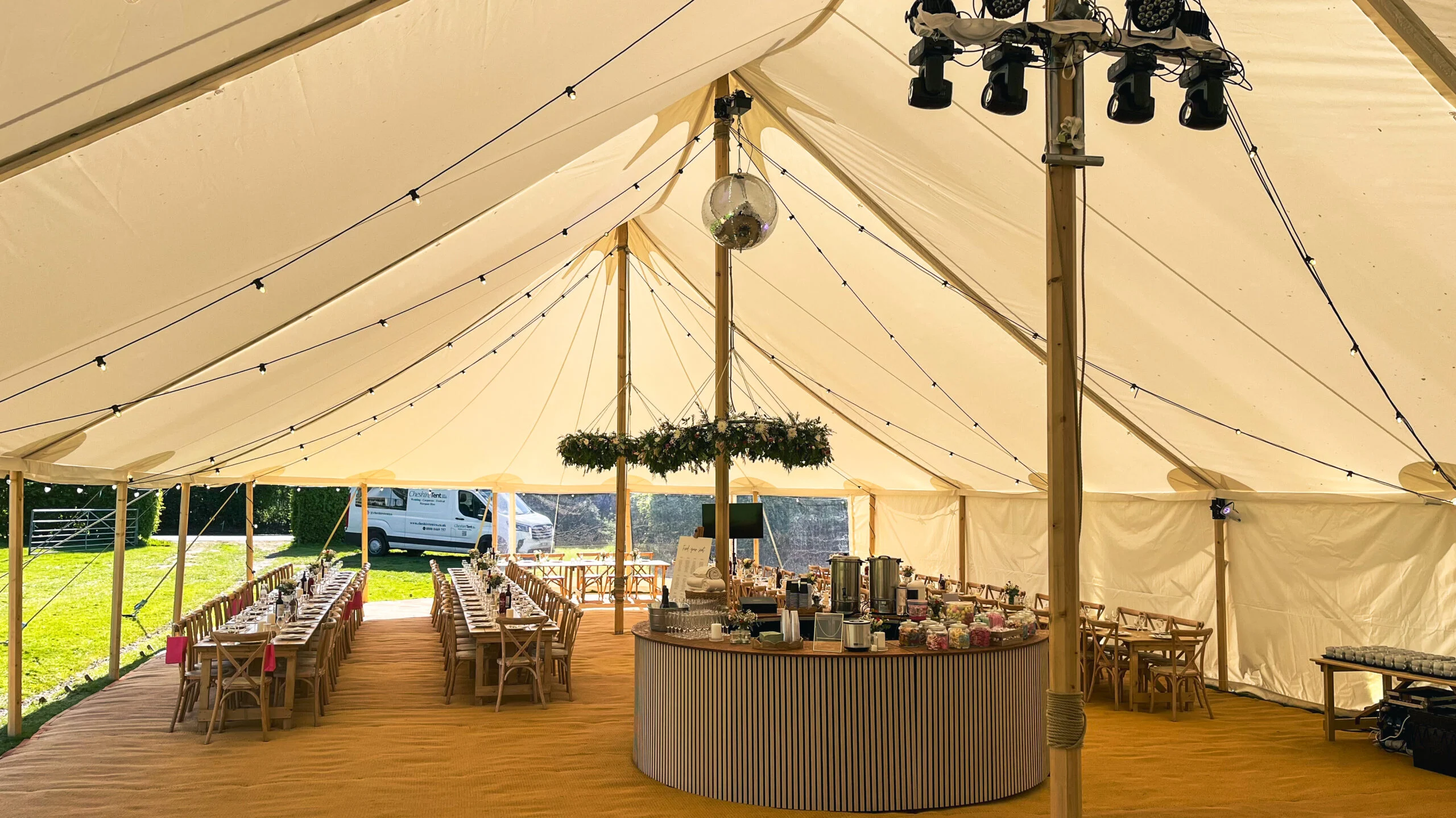 Marquee interior with a circular bar and suspended lighting