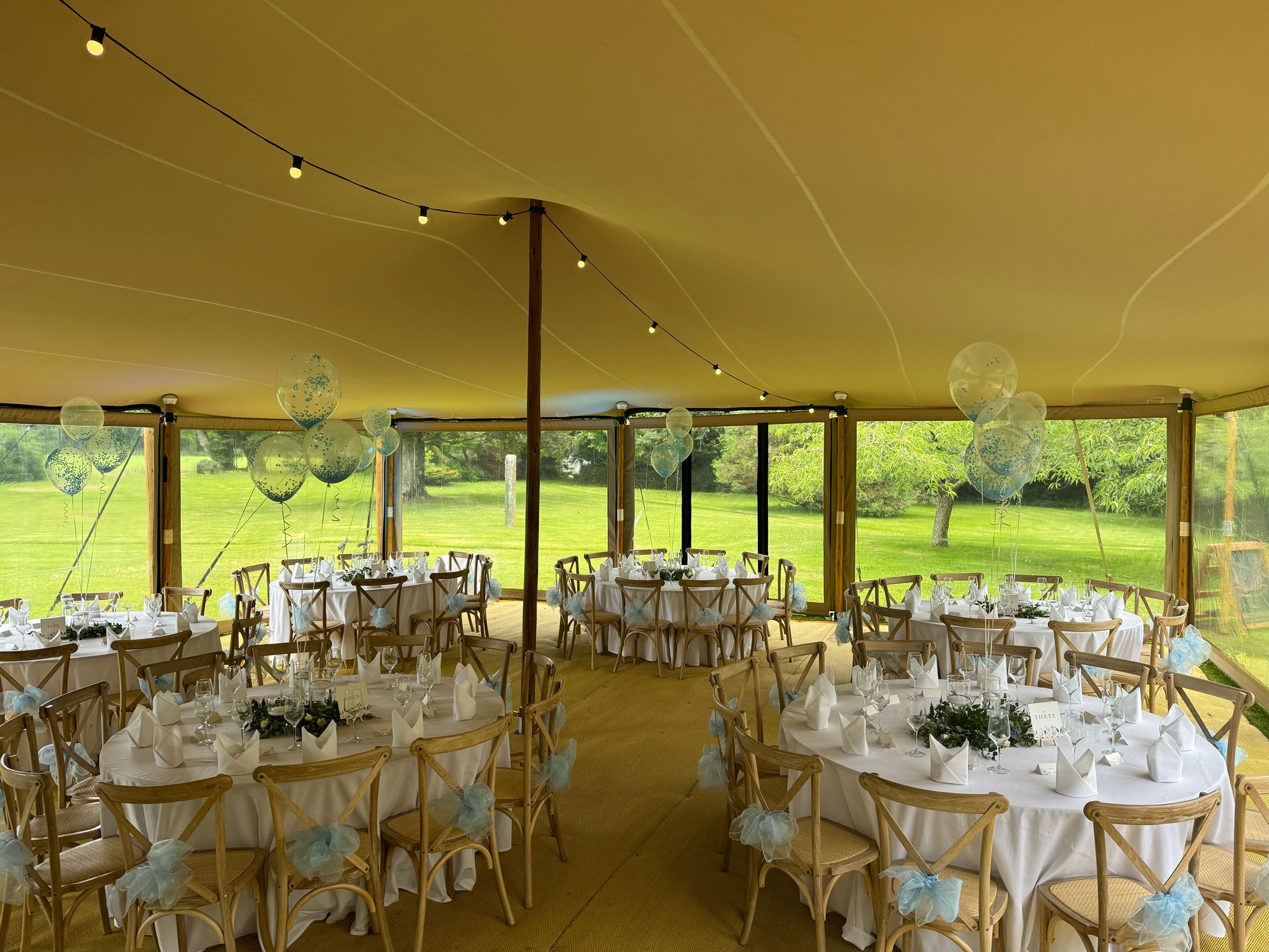 Dining tables arranged beneath a stretch tent — example for events in Congleton