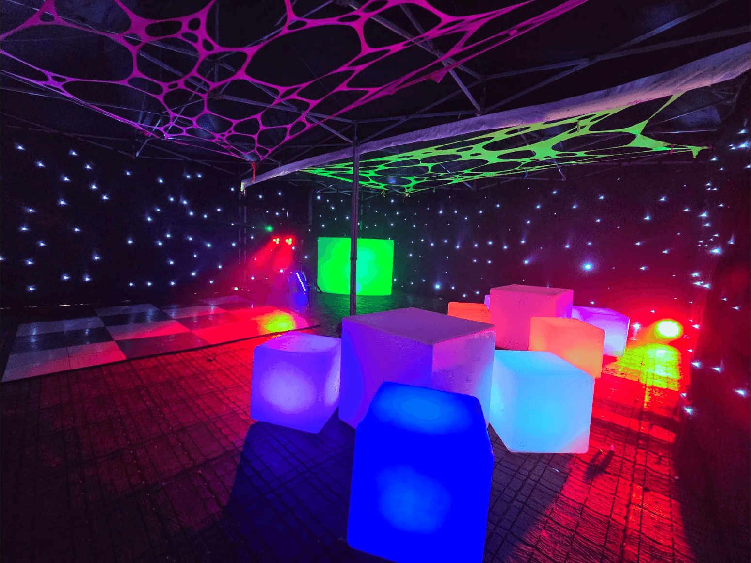 Party tent interior with colourful illuminated seats — example for events in Alderley Edge