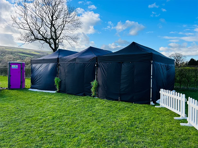 Dark party tents set up in a garden — example for events in Alderley Edge